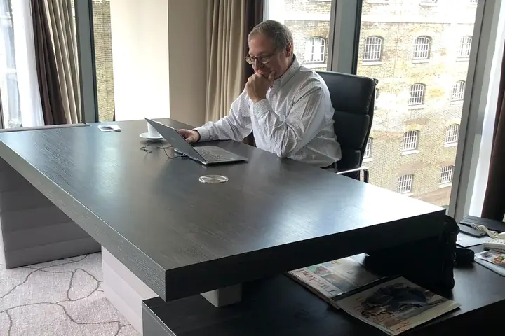 Ken Bausch working at a laptop during a business trip in London.
